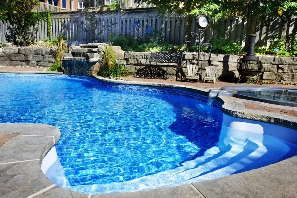Concrete swimming pool in the backyard